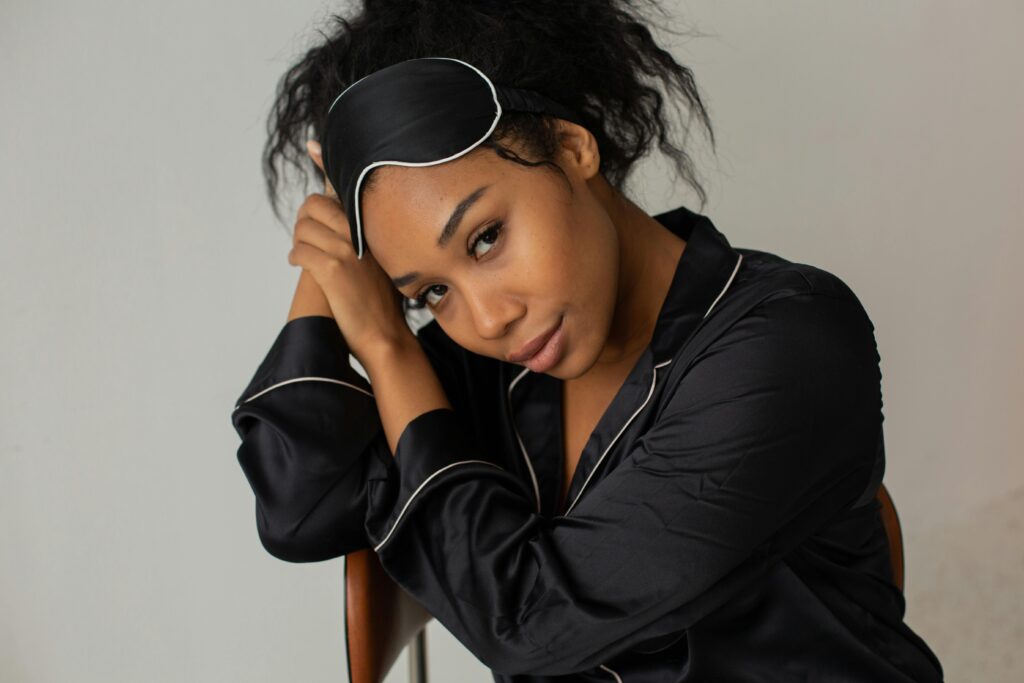 Home Close-up portrait of a woman in pajamas with a sleep mask, exuding calm and relaxation.